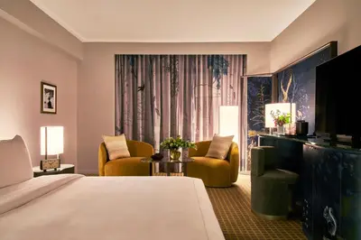 a hotel room with a bed and two chairs at Park Lane New York in New York