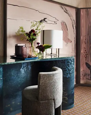 a living room with a chair and a table with a lamp at Park Lane New York in New York