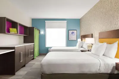 a hotel room with two beds and a kitchen at Home2 Suites By Hilton Ridley Park Philadelphia Airport So in Ridley Park