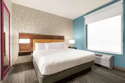 a bedroom with a large bed and a large window at Home2 Suites By Hilton Ridley Park Philadelphia Airport So in Ridley Park