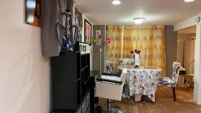 a dining room with a table with a vase on it at Garden Suite 30 Mins to NYC, Mins to EWR, Prudential Center, NJPACK in Belleville