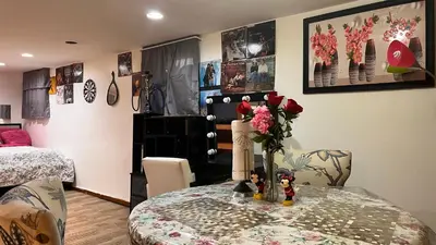 a room with a table with a vase of flowers on it at Garden Suite 30 Mins to NYC, Mins to EWR, Prudential Center, NJPACK in Belleville
