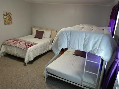 a bedroom with two bunk beds and a small bed at Hotel Wayne in Honesdale