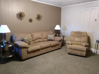 a living room with a couch and a chair at Hotel Wayne in Honesdale