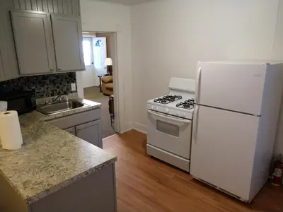 a kitchen with a white stove and a refrigerator at Hotel Wayne in Honesdale