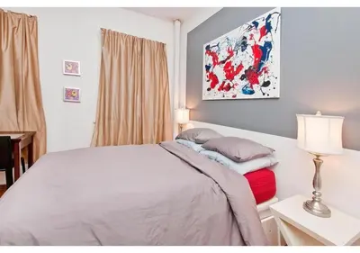 a bedroom with a bed and a table with a lamp at great studio apt new york city in New York