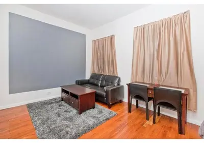 a living room with a leather couch and a desk at great studio apt new york city in New York