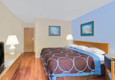 a hotel room with a bed and a tv at Super 8 by Wyndham Newburgh/West Point Stewart Intl Airport in Newburgh
