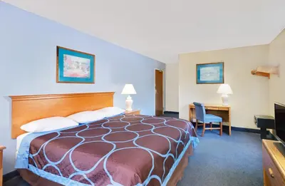 a hotel room with a bed and a desk at Super 8 by Wyndham Newburgh/West Point Stewart Intl Airport in Newburgh
