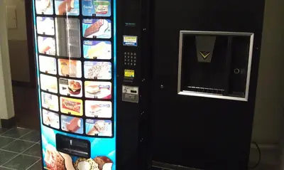 a vending machine filled with food and drinks at Super 8 by Wyndham Newburgh/West Point Stewart Intl Airport in Newburgh