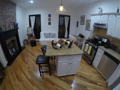a small child laying on a counter in a kitchen at Historic 1869 Brownstone 15 min to NYC downtown in Jersey City