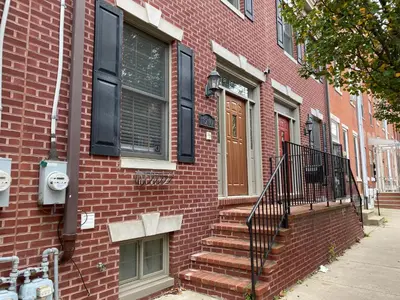 a red brick building with stairs leading to a door at AF Stays - Philadelphia 1210 Mt Vernon St in Philadelphia