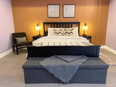 a bedroom with a large bed and a chair at AF Stays - Philadelphia 1210 Mt Vernon St in Philadelphia