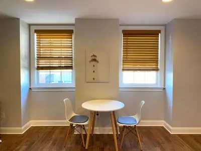 a table and chairs in a room with two windows at AF Stays - Philadelphia 1210 Mt Vernon St in Philadelphia