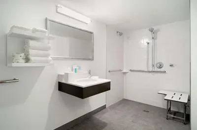 a white bathroom with a sink and a mirror at Hampton Inn Philadelphia Center City-Convention Center in Philadelphia