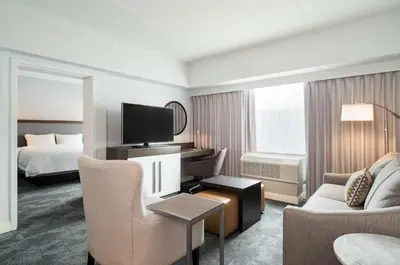 a hotel room with a bed and a living room at Hampton Inn Philadelphia Center City-Convention Center in Philadelphia
