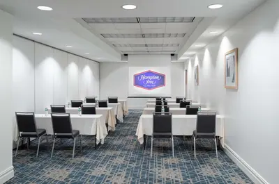 a conference room with tables and chairs and a sign at Hampton Inn Philadelphia Center City-Convention Center in Philadelphia