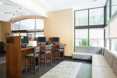 an office with a bar with stools and a couch at Hampton Inn Philadelphia Center City-Convention Center in Philadelphia
