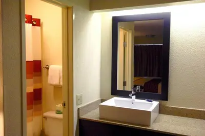 a bathroom with a sink and a mirror at Red Roof Inn PLUS+ Philadelphia Airport in Essington