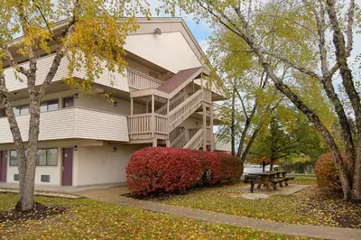 a building with a picnic table in front of it at Red Roof Inn PLUS+ Philadelphia Airport in Essington