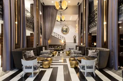a lobby of a hotel with chairs and tables at The Empire Hotel New York in New York