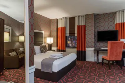 a hotel room with a bed and a desk at The Empire Hotel New York in New York