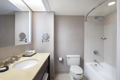 a bathroom with a sink and a toilet and a tub at Sheraton Edison in Edison