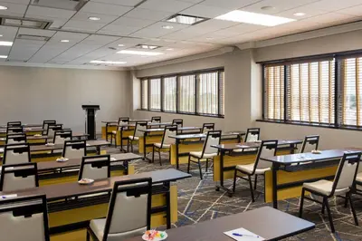an empty classroom with tables and chairs at Sheraton Edison in Edison