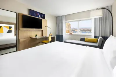 a hotel room with a bed and a television at M Social Hotel New York Times Square in New York