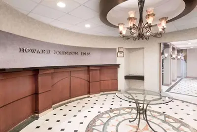 a waiting room with a glass table in a lobby at Howard Johnson by Wyndham Newburgh in Newburgh