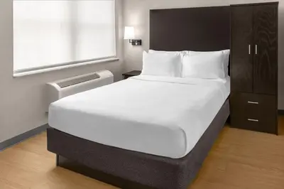 a large white bed in a room with a window at Solita Soho Hotel in New York
