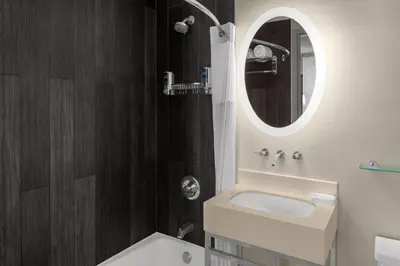 a bathroom with a sink and a mirror at Solita Soho Hotel in New York