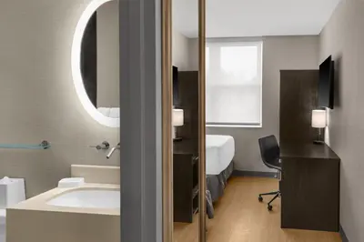 a bathroom with a sink and a mirror at Solita Soho Hotel in New York