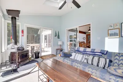 a living room with a blue couch and a wooden table at Mt. Maplewood Lake House in Blakeslee