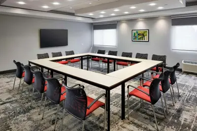 a conference room with a table and chairs at Hampton Inn Newark Airport in Newark