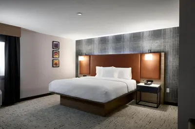 a bedroom with a large bed with a white blanket at Hampton Inn Newark Airport in Newark