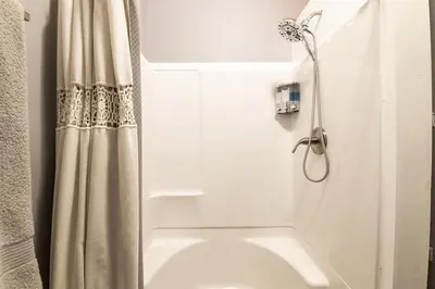 a shower in a bathroom with a shower curtain at Riverfront Penthouse Suite in Midtown Harrisburg near Hershey in Harrisburg
