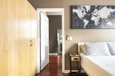a bedroom with a bed and a map on the wall at Riverfront Penthouse Suite in Midtown Harrisburg near Hershey in Harrisburg