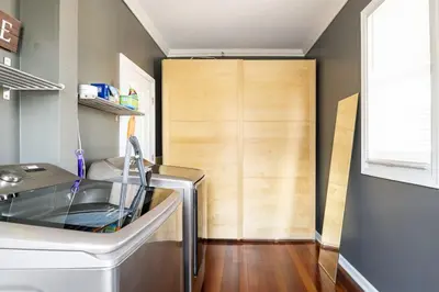 a kitchen with a glass table and a wooden door at Riverfront Penthouse Suite in Midtown Harrisburg near Hershey in Harrisburg