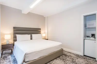 a white bedroom with a bed and a window at Lombardy Hotel in New York