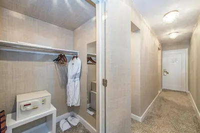 a bathroom with a walk in shower and a microwave at Lombardy Hotel in New York