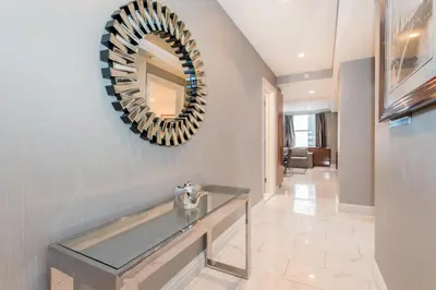 a hallway with a glass counter and a mirror at Lombardy Hotel in New York