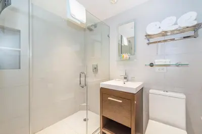 a bathroom with a shower and a sink and a toilet at Lombardy Hotel in New York