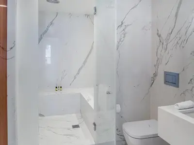 a white bathroom with a shower and a toilet at 33 Hotel, New York City, Seaport in New York