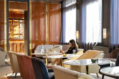 a woman sitting at a table in a restaurant at 33 Hotel, New York City, Seaport in New York