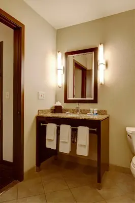a bathroom with a sink and a toilet and a mirror at Hyatt House Philadelphia-King of Prussia in King of Prussia