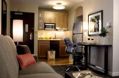 a living room with a couch and a kitchen at Hyatt House Philadelphia-King of Prussia in King of Prussia