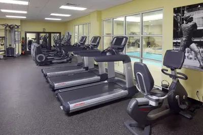 a gym with a row of treadmills and exercise bikes at Hyatt House Philadelphia-King of Prussia in King of Prussia