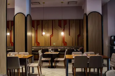 a dining room with tables and chairs and a wall at DoubleTree by Hilton New York Times Square South in New York
