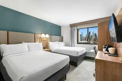 a hotel room with two beds and a window at Holiday Inn Manhattan 6th Ave - Chelsea by IHG in New York